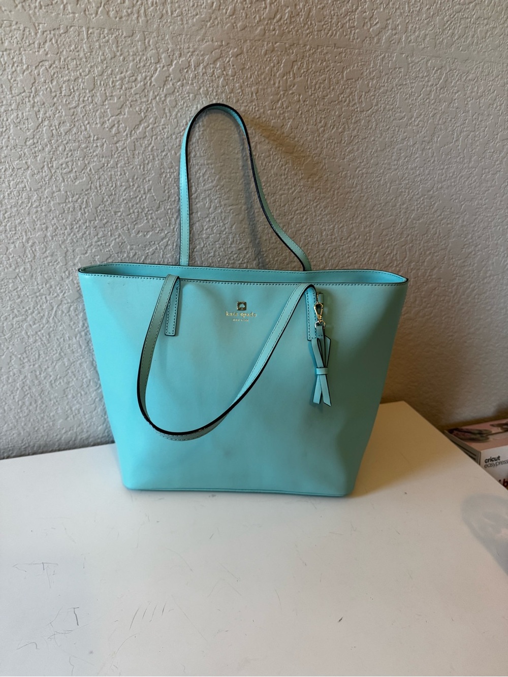 Kate Spade turquoise leather tote with tassel charm